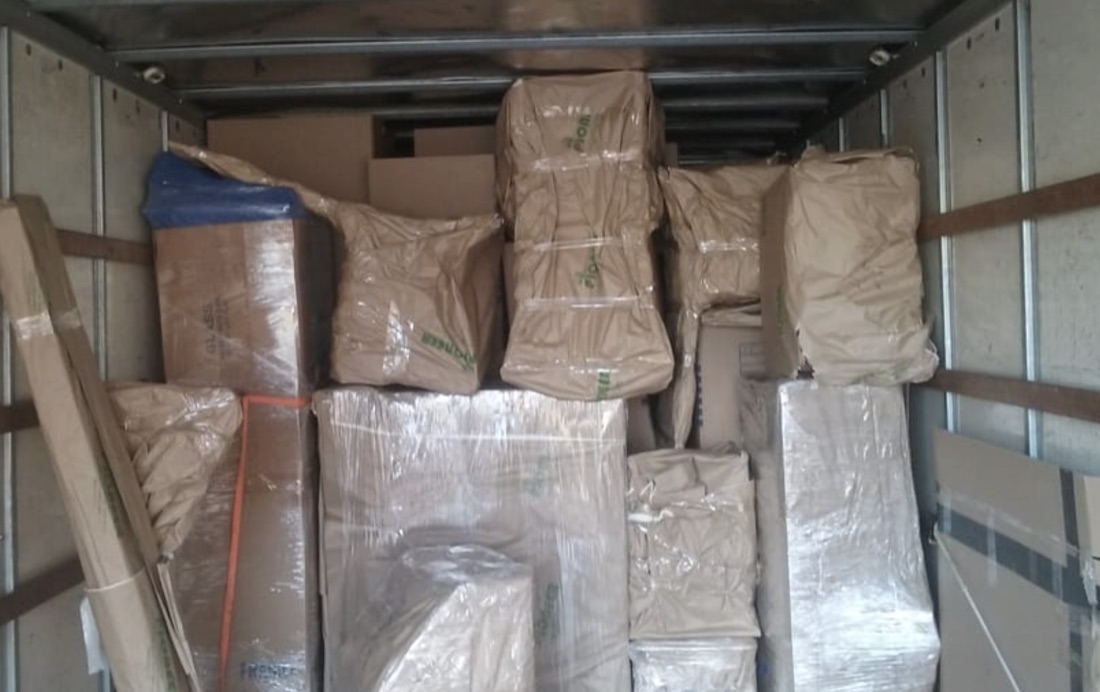 Furniture and boxes professionally wrapped and loaded inside an MFL moving truck
